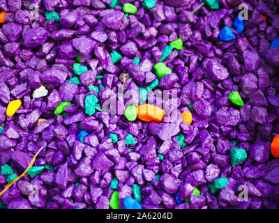 purple little pebbles. The background consists of small purple pebbles. With many possible uses. The texture is made up of tiny purple pebbles. Stock Photo