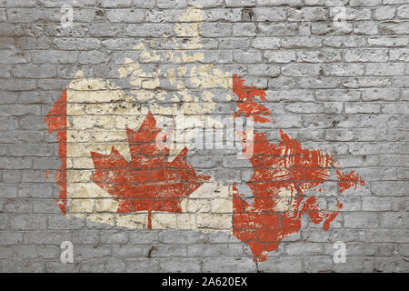 Grunge distressed map shaped flag of Canada painted on old weathered grey brick wall Stock Photo