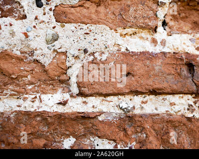 old brickwork. Fragment of an old wall with brickwork. Background. Uneven, obsolete, ancient, medieval, wallpaper, surface, chipped, weathered Stock Photo