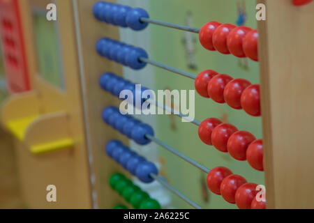 Toy abacus to learn counting. Colorful children counting frame for kids. Top side view.abacus with red green blue and balls . Traditional abacus with Stock Photo