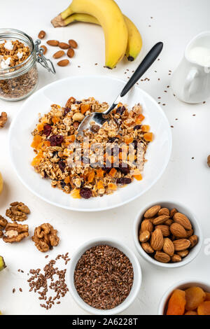 Bowl With Tasty Oatmeal, Almonds, Bananas And Strawberries On Pink 