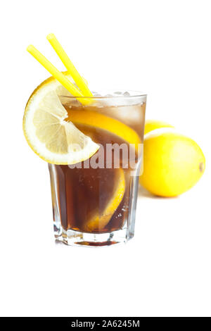 Cuba Libre in front of two lemons isolated on white background Stock Photo