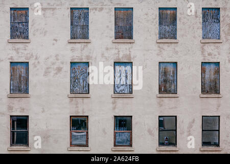 Boarded up windows from an abandoned building in the USA. Stock Photo