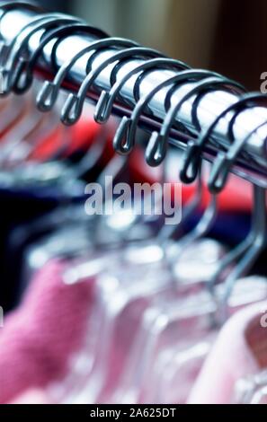 Lineup of Hangers and clothing in a boutique clothing store Stock Photo