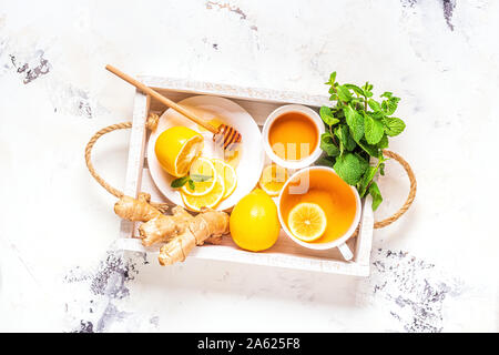 Green tea with lemon and honey, Immunity boosting and cold remedies, top view. Stock Photo