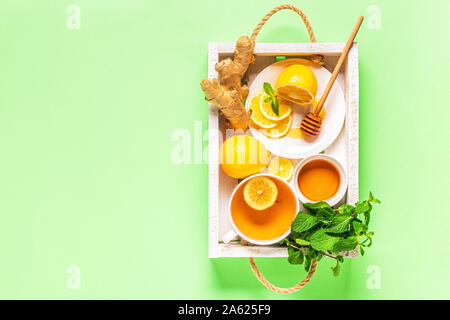 Green tea with lemon and honey, Immunity boosting and cold remedies, top view. Stock Photo