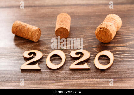 Happy New Year 2020. The number 2020 on brown background. Stock Photo