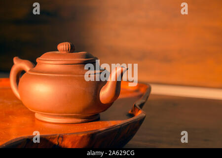 Retro clay Chinese teapot on a brown background Stock Photo