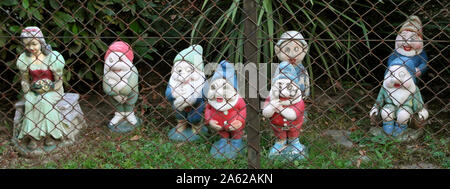 Snow white and seven dwarfs behind the  wire mesh - Brothers Grimm Stock Photo