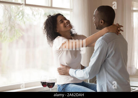 Laughing just married family couple enjoying weekend time at kitchen. Stock Photo