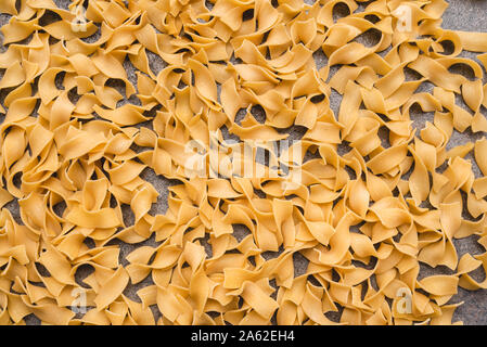 Different types of pasta that we use every day in the kitchen when cooking. View from above. Products flat-lying. Place for a description or text. Stock Photo