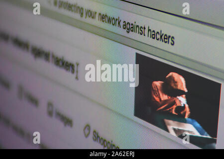 Close-up on the screen, search topic: "protecting your network against hackers". Stock Photo