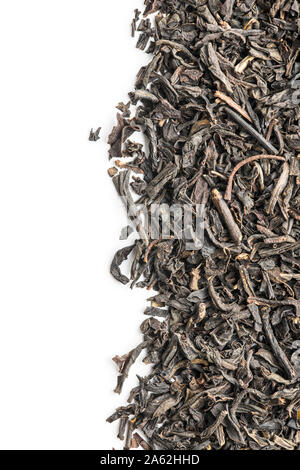 Dried black tea leaves isolated on white background. Stock Photo