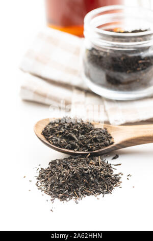Dried black tea leaves isolated on white background. Stock Photo