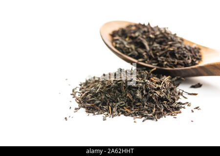 Dried black tea leaves isolated on white background. Stock Photo