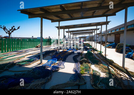 Fishing nets laid out to dry under shelters at the fishing port in Peniscola Spain Stock Photo