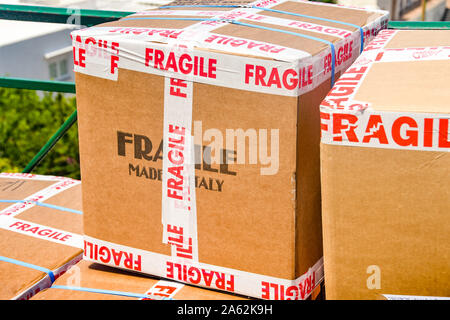 Cardboard boxes secured with sticky tape marked 'Fragile' Stock Photo