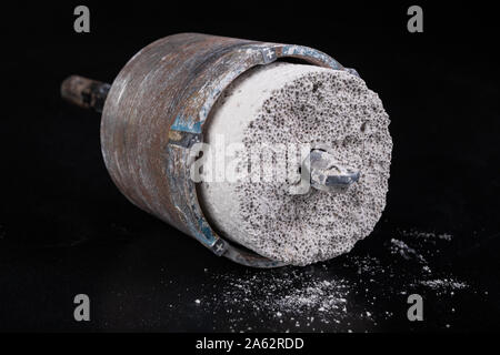 Steel large drill for drilling holes in concrete. Hole saw used to make holes for electrical boxes. Dark background. Stock Photo