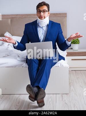 The businessman with neck injury working from home Stock Photo