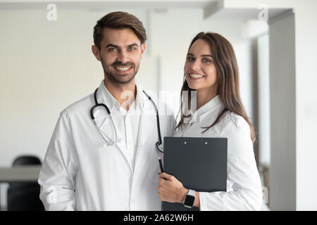 Smiling professionals male doctor and female nurse looking at camera Stock Photo
