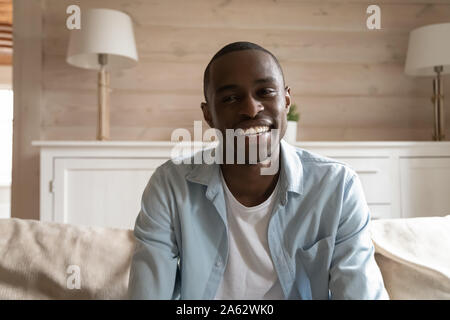 Smiling mixed race young man holding video conference call. Stock Photo