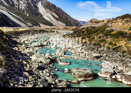 The turquoise water of the river flowing through the Hooker Valley track in Aoraki National Park