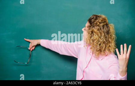 School lesson knowledge. Remember this. Strict woman teacher pointing at chalkboard. Informing kids. School rules. School principal stressful outraged expression. Educational system concept. Stock Photo