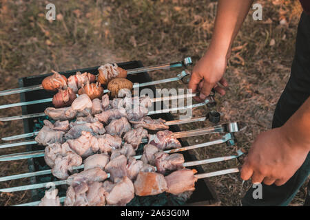 Shish kebab of meat skewered on a grill close-up outdoors Stock Photo -  Alamy