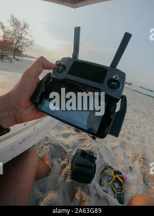 Gadgets for drone control and hand watches for multicopter control on the beach Stock Photo