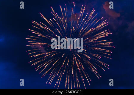 Inexpensive fireworks, over the city, white, red and yellow. For any purpose. Stock Photo