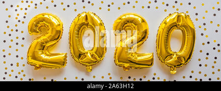 Foil balloons golden color in the form of numbers 2020. New year celebration, christmas, xmas. Flat lay with Air Balloons, top view, mockup, overhead Stock Photo
