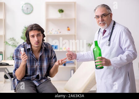 The young male alcoholic visiting old doctor Stock Photo