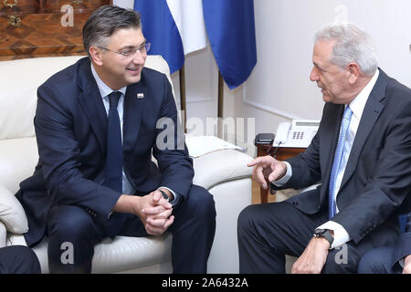 (191024) -- ZAGREB, Oct. 24, 2019 (Xinhua) -- Croatian Prime Minister Andrej Plenkovic (L) speaks with European Commissioner for Migration, Home Affairs and Citizenship Dimitris Avramopoulos in Zagreb, Croatia, Oct. 23, 2019. Avramopoulos said here on Wednesday that the European Union (EU) could better face migration and security challenges with Croatia in the Schengen area. (Patrik Macek/Pixsell/Handout via Xinhua) Stock Photo