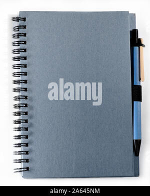 Spiral bound notebook with attached pen, isolated on white. Stock Photo