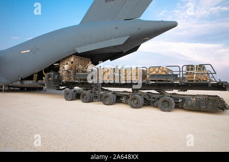 A Tunner 60K Aircraft Cargo Loader loads ammunition onto a C-17 at Kobani Landing Zone (KLZ), Syria, Oct. 21, 2019. U.S. forces are executing a deliberate, phased, and orderly withdrawal from northern Syria. KLZ remains open to facilitate the additional movement of troops and equipment outside of Syria. (U.S. Army Reserve photo by Staff Sgt. Joshua Hammock) Stock Photo