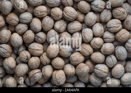 Natural walnut background pattern texture Abstract walnuts heap pattern background. Walnuts in shell close up, top view Stock Photo