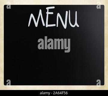 The word 'Menu' handwritten with white chalk on a blackboard Stock Photo
