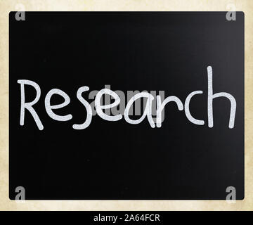 'Research' handwritten with white chalk on a blackboard Stock Photo