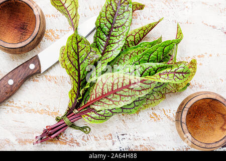 Bunch of fresh sorrel on wooden background.Sorrel bloody mary Stock Photo