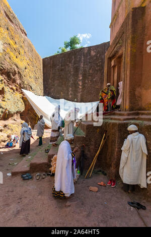 LALIBELA, ETHIOPIA, MAY 1st. 2019, Orthodox Christian Ethiopian believer on stairs in front of famous rock-hewn St. George's Church after Mass on May Stock Photo