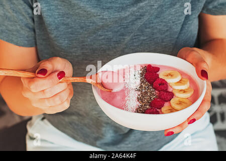 Woman's hands close up holding smoothie bowl Stock Photo