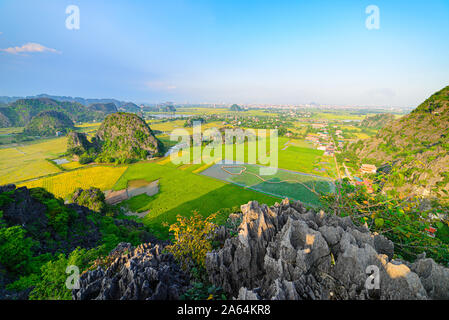 Epic aerial view of Ninh Binh region, Trang An Tam Coc tourist attraction, UNESCO World Heritage Site, Scenic river and rice padies among karst mounta