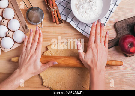 Woman's hands close up rolling dough for apple pie Stock Photo