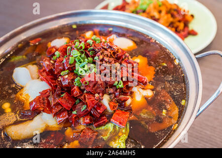 Asia, China food. Szechuan water boiled spicy fresh fish. Fried Chicken side dish. Chengdu Chongqing hotpot food culinary. Stock Photo