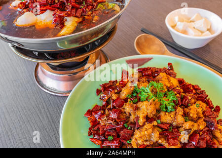 Asia, China food. Szechuan water boiled spicy fresh fish. Fried Chicken side dish. Stock Photo