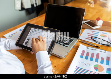 Closeup of businesswoman working with tablet computer at office desk. Stock Photo