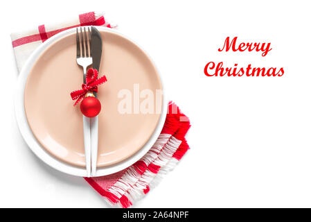 Christmas Table Setting with red ribbon and ornaments on white, flat lay, copy space. Christmas dinner, party design, concept - table setting with fes Stock Photo