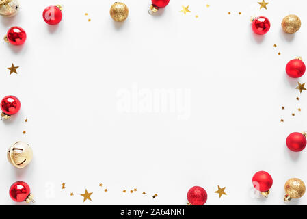 Christmas Background with golden and red festive balls and stars, isolated on white background,  copy space. Christmas creative flat lay, concept with Stock Photo