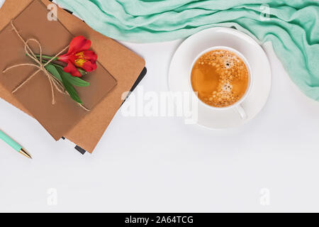 Stylish femine flat lay with mint colored scarf, coffee and envelopes Stock Photo