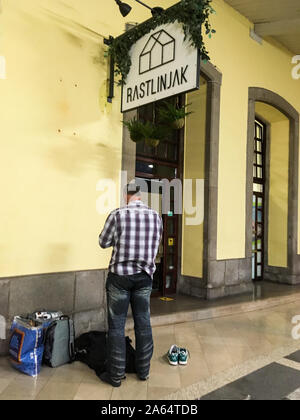 Muslim faithful praying on a platform at Ljubljana railway station, Ljubljana, Slovenia Stock Photo